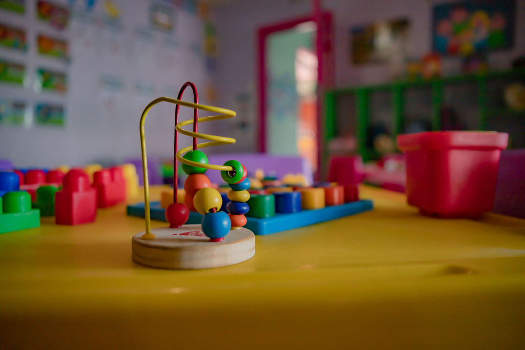 Colourful wooden bead-maze learning toy in a Kosi Kasi classroom