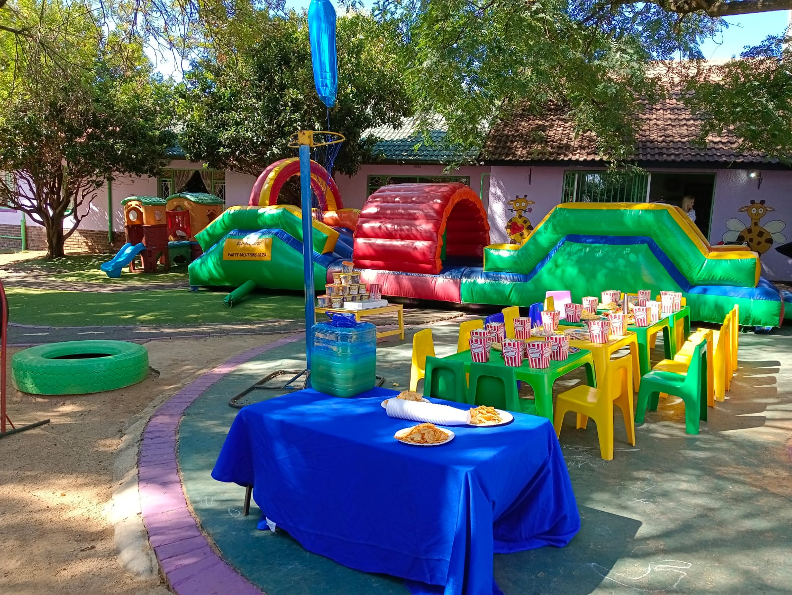 A birthday party set up at Kosi Kasi with decorated tables and jumping castles