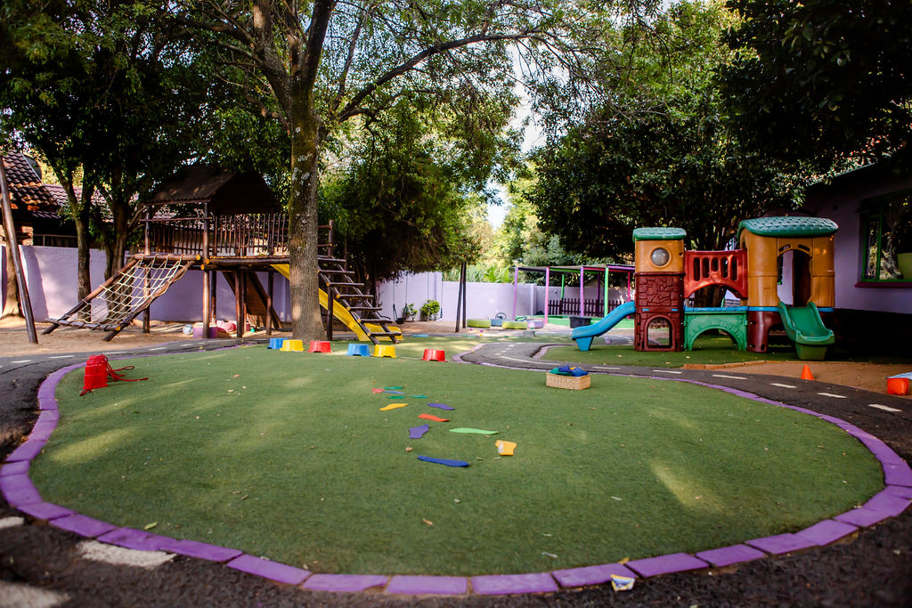 Kosi Kasi outdoor play area with jungle gym, slides and a soft circular lawn